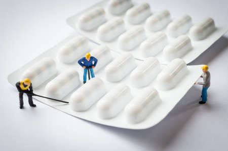miniature people on the drugs or pilsの写真素材