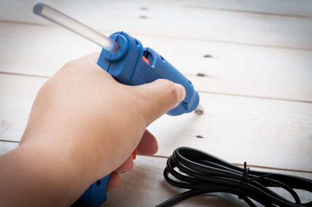 Hand holding glue gunの写真素材