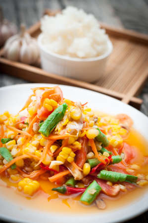 Papaya Salad with Corn and sticky rice on wooden boardの写真素材