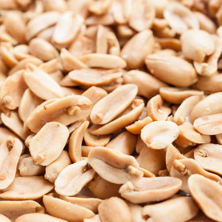 Peanuts. Close up of fried, peeled and salted peanuts on white backgroundの写真素材