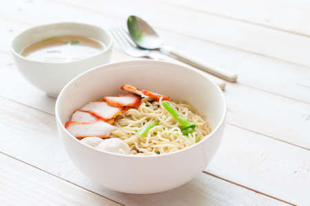 Noodles Soup with Fish Balls on wood tableの写真素材