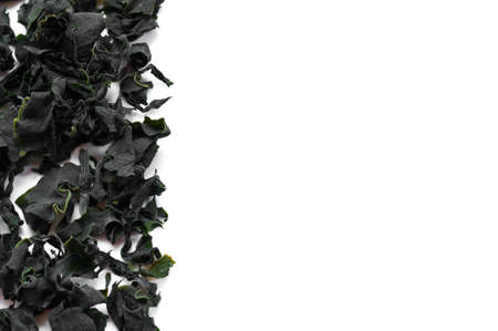 Dried japanese wakame seaweed isolated over whiteの写真素材
