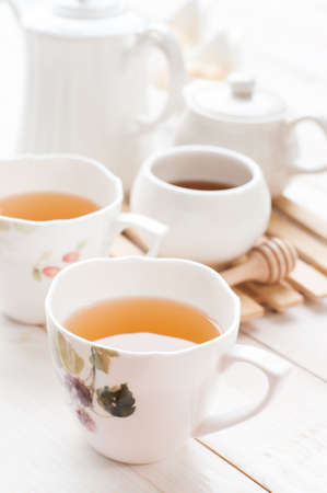 Cup of ginger tea with honey and lemon on wooden tableの写真素材