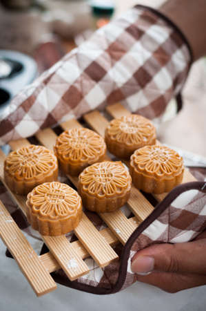 Retro vintage style Chinese mid autumn festival foods. Traditional mooncakes on tableの写真素材