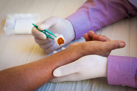 doctor dressing wound at the emergency roomの写真素材