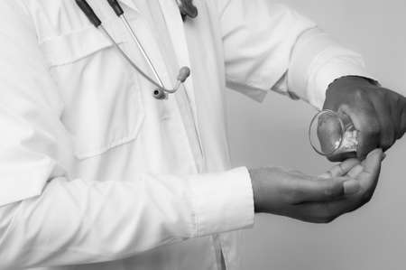 Doctor pouring pills on his palm