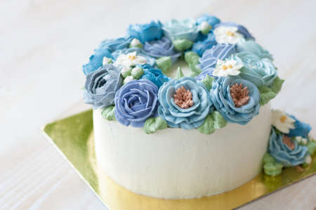 cake with blue buttercream flowerの写真素材