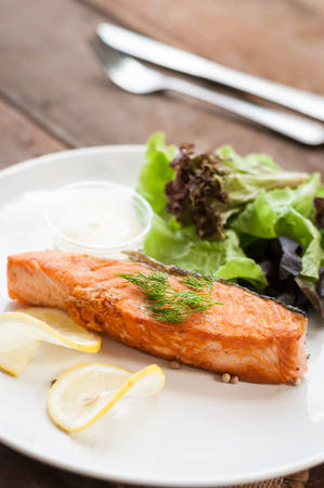 Salmon steak grilled with lemonの写真素材