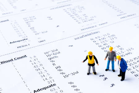 Miniature people on the drugs or with medical check up lab result, medical conceptの写真素材