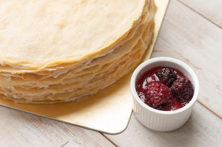 Crepe cake with blackberry sauceの写真素材