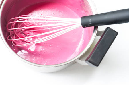 Pink cream mixing in stainless steel potの写真素材