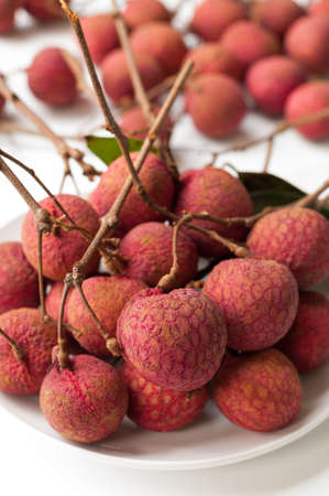 lychee berries on white dishの写真素材
