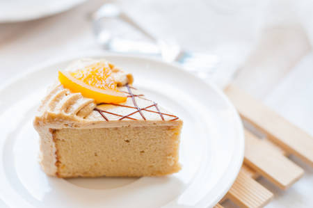 Afternoon tea set and coffee cake on white wooden board in soft toneの写真素材