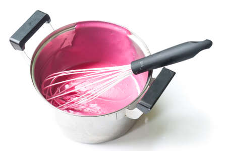 Pink cream mixing in stainless steel potの写真素材