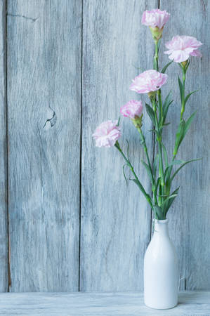 Pink carnation on wooden backgroundの写真素材