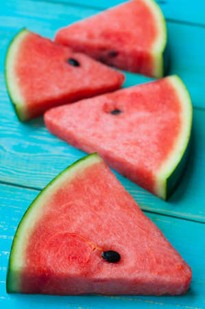 Slices of Watermelon on blue wooden backgroundの写真素材