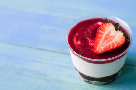 Strawberry mousse cake on blue wooden boardの写真素材