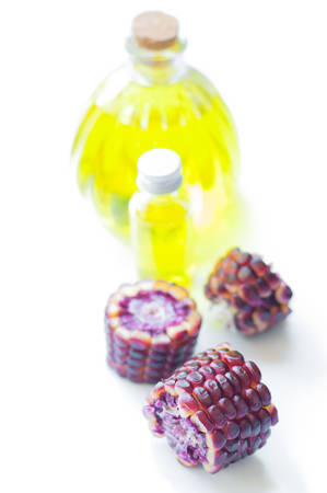 Ruby corn with oil in bottleの写真素材