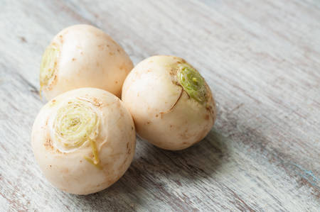 Whole headed turnips on wooden backgroundの写真素材