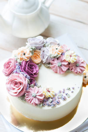 beautiful buttercream flower cake on wooden boardの写真素材