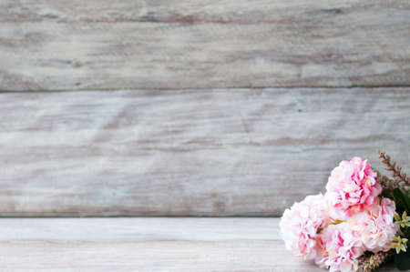 Beautiful artificial flowers on wooden backgroundの写真素材