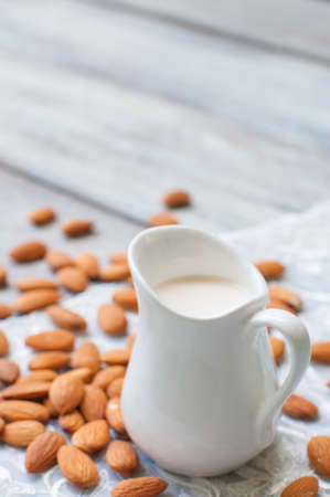 almond milk on burlap and wooden backgroundの写真素材