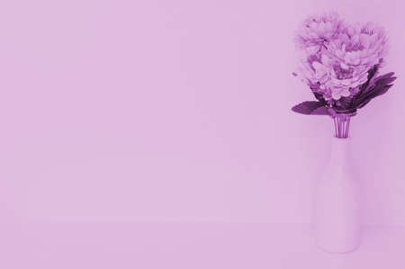 Beautiful artificial flowers on orange curtain backgroundの写真素材