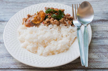 Fried century egg with crispy holy basil leaves and riceの写真素材