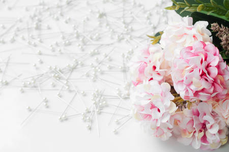 Beautiful artificial flowers with sewing pin backgroundの写真素材