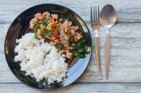 Fried century egg with crispy holy basil leaves and riceの写真素材