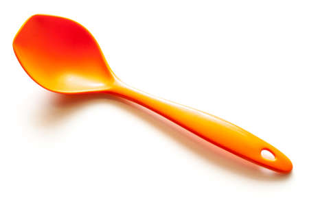 Orange plastic ladle isolated on white backgroundの写真素材
