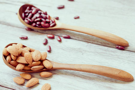 almond and kidney bean in  wooden spoonの写真素材