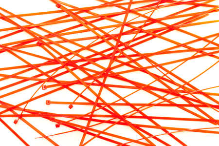 Orange plastic cable ties on grey backgroundの写真素材