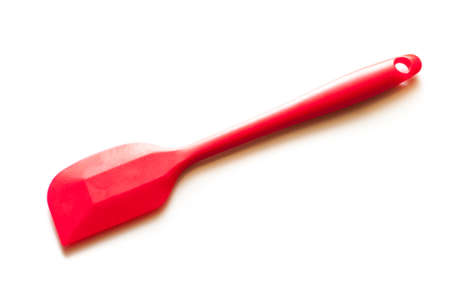 red silicone baking spatula isolated on white backgroundの写真素材