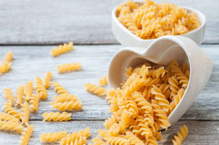 Fusilli whole wheat organic pasta in a heart shape ramekinの写真素材