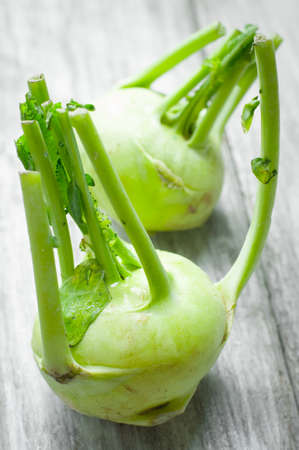 Green kohlrabi on wooden backgroundの写真素材