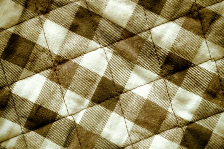 Old brown checkered pattern fabric backgroundの写真素材