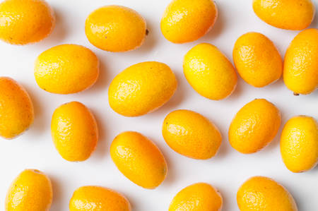 Orange kumquat fruit on grey backghroundの写真素材
