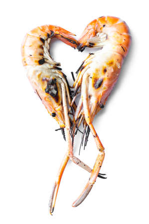 Grilled shrimps in heart shape isolated on white backgroundの写真素材