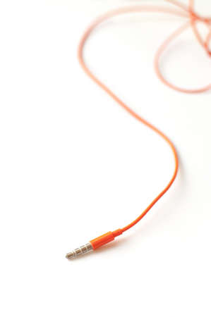 audio jack with orange cable isolated on white backgroundの写真素材