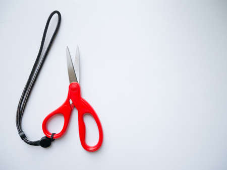 Red scissors on grey backgroundの写真素材
