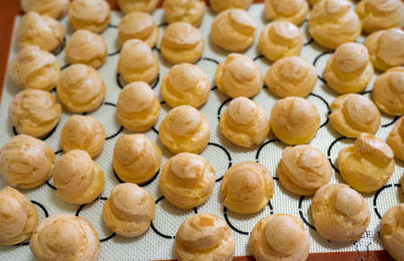 Baking choux pastry on silpatの写真素材
