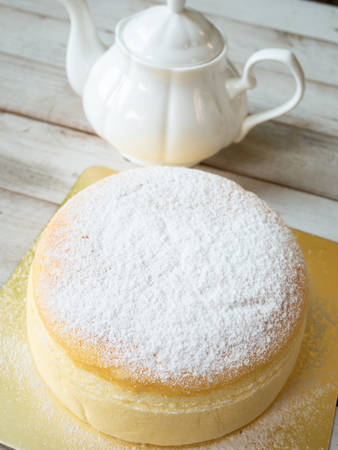 Japanese cheese cake with tea in teapotの写真素材