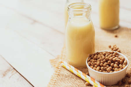 Soy milk with soy bean on wooden boardの写真素材
