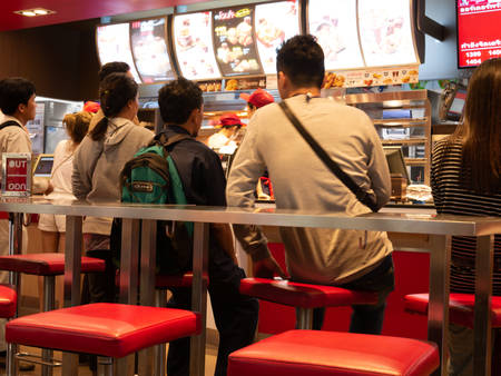 Pathumthani, Thailand - MAY 16, 2018: Peple waiting at KFC Fast Food shop. KFC is a Worldwide Famous...