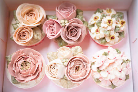 Set of buttercream flower cupcakes in a boxの写真素材