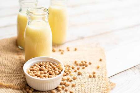 Soy milk with soy bean on wooden boardの写真素材