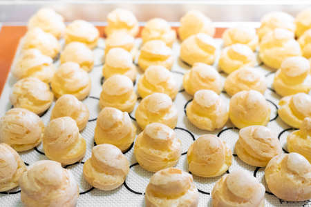 Baking choux pastry on silpatの写真素材