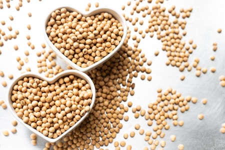 Soy beans in heart shape bowl isolated on white background
