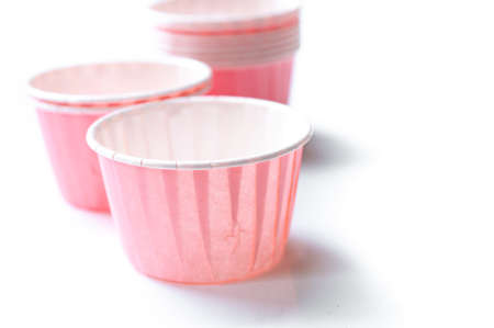 Pink paper cup for cupcake isolated on white background